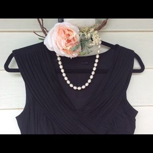 Floor length black gown.